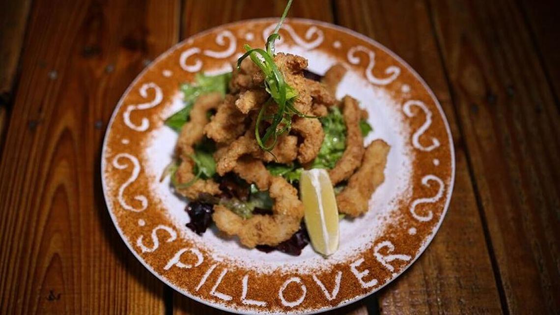 Fried Bahamian conch and grouper strips served with creamy garlic sauce are pounded into tender bits of salty goodness at Spillover.