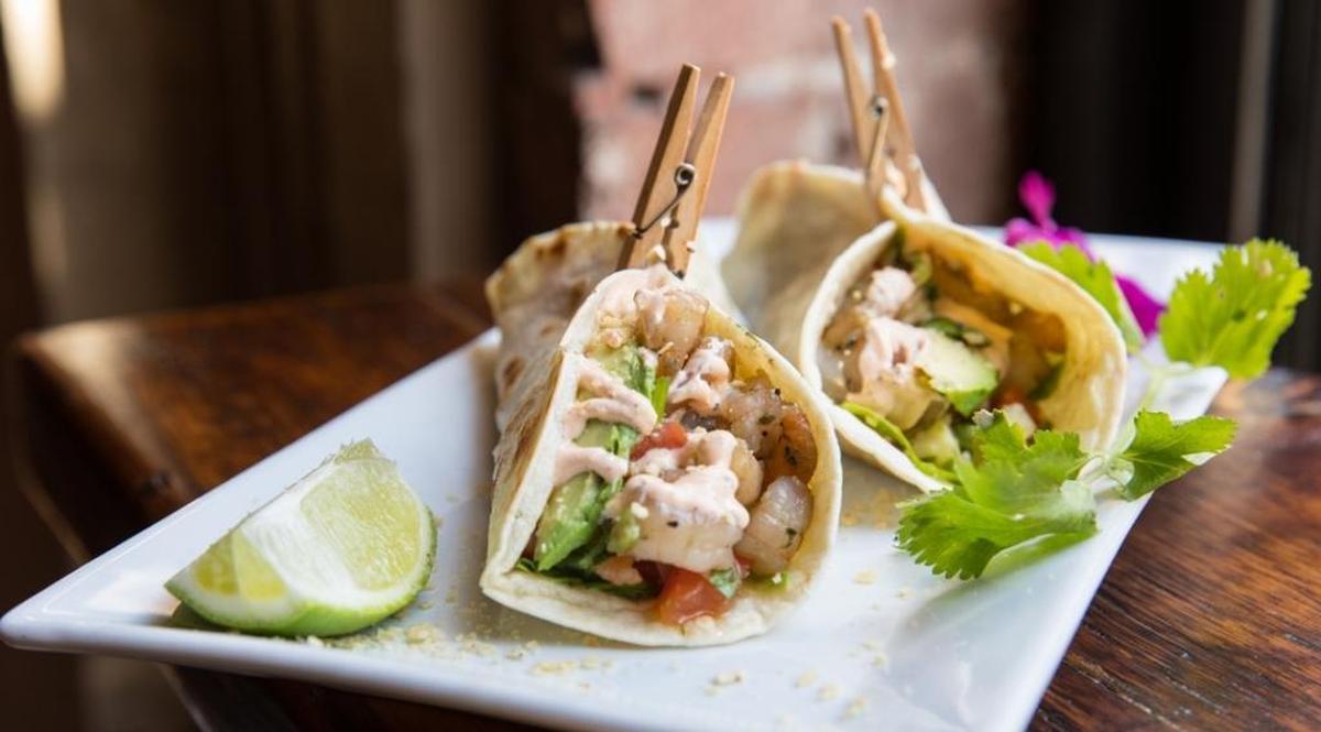 Shrimp tacos with lime, cilantro and avocado in a flour tortilla with spicy mayo at The Craftsman.