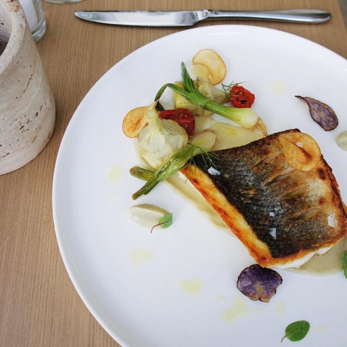 A golden, skin-on branzino filet over a delicate artichoke puree with crispy fried fingerling potatoes is a study in simplicity at Forte dei Marmi.