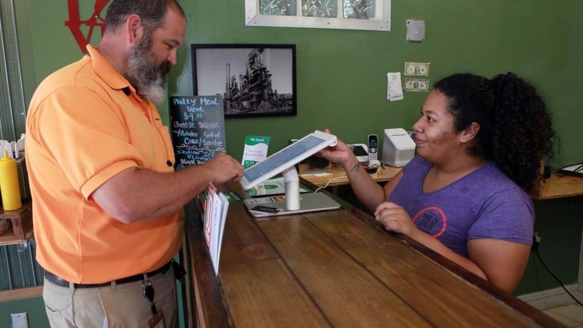 Good food brings the customers, which helps build a neighborhood. Katherine Mayta takes Chao Cameron’s order at Philly Grub restaurant in Little Haiti. Owner Mark Scharnitz took a gamble buying the space for his restaurant years ago, before Little Haiti began to emerge.