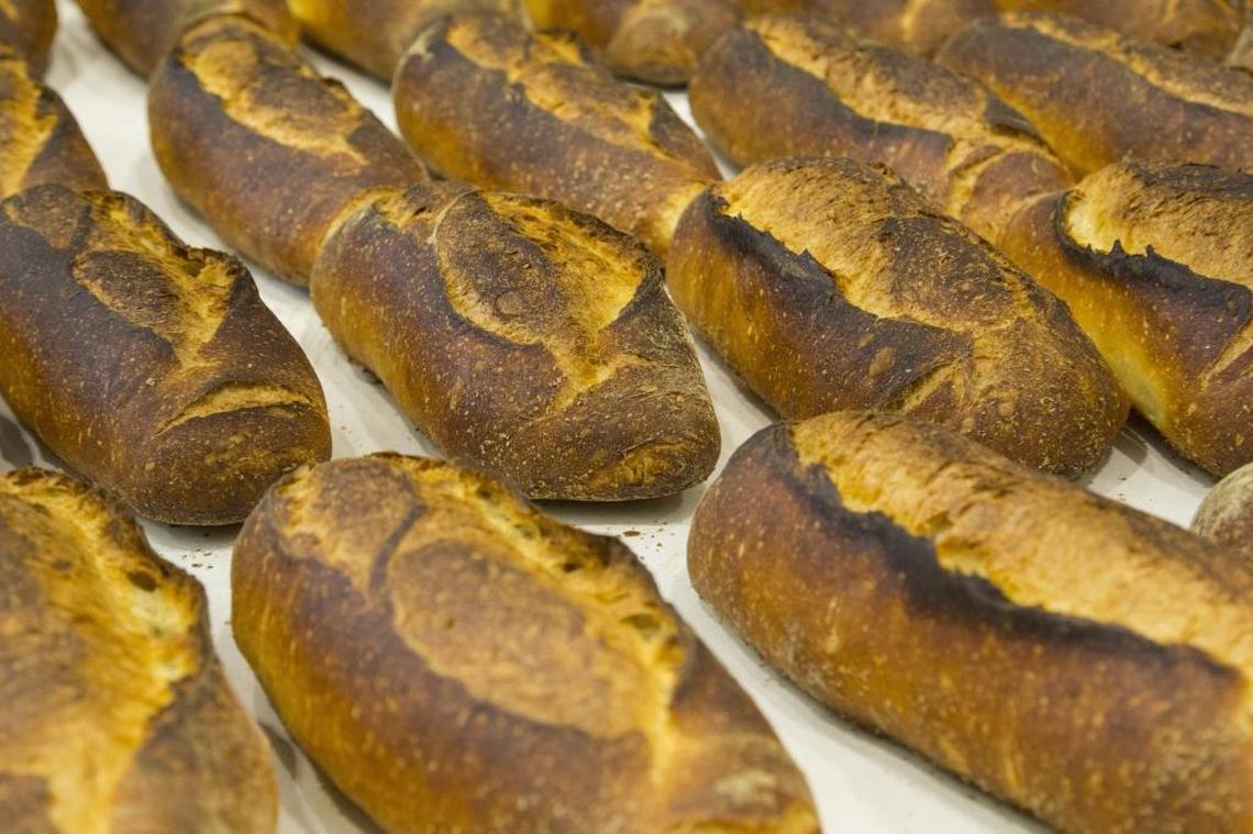 A batch of fresh Pugliese Bread is removed from the oven at Sullivan Street Bakery in Little Haiti. The bakery is making three kinds of bread for now, but will expand their lineup by the fall.