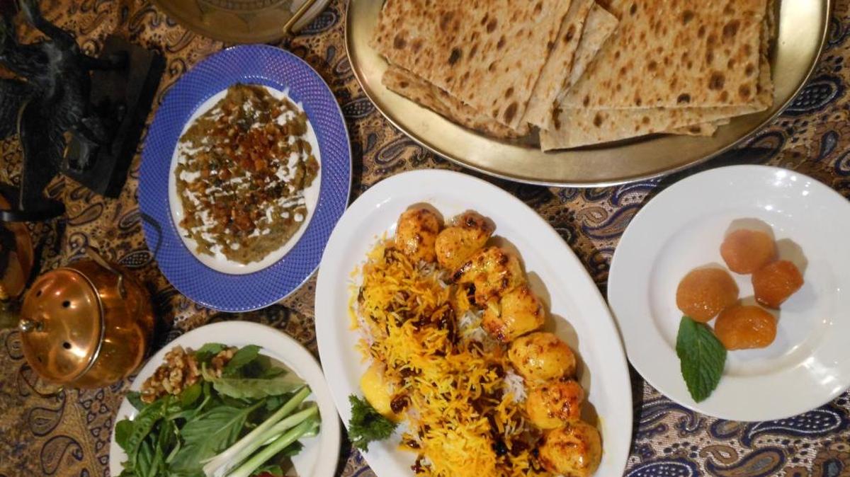 Eggplant dip, Persian flatbead, rice with chicken and fresh herbs and feta at Kababi Cafe in Sunrise.