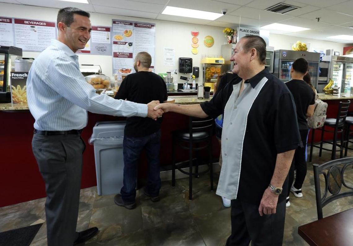 Frequent customer Daniel Torres greets Manolo Lirio at Manolo and Rene café’s new downtown location of Manolo and Rene, at 281 NE 1st St., which is across the street from where Torres works. Manolo opened the original Manolo and Rene's Cafeteria in downtown Miami more than 40 years ago but longtime customers are still stumbling on the new location after Hurricane Irma shut them down.