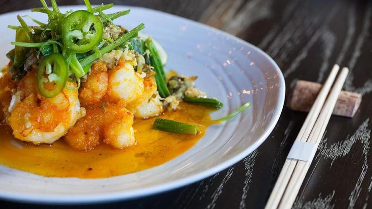 Lightly breaded salt-and-pepper shrimp sizzle and dance in a sticky ginger scallion sauce jazzed up by Szechuan pepper.
