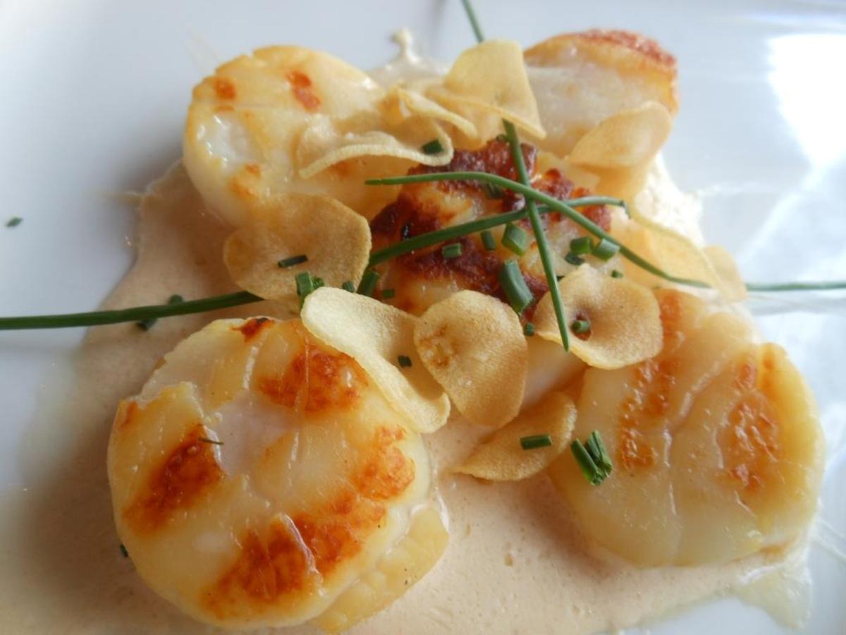 Seared scallops in creamy white truffle sauce with fried elephant garlic at Fifi’s.