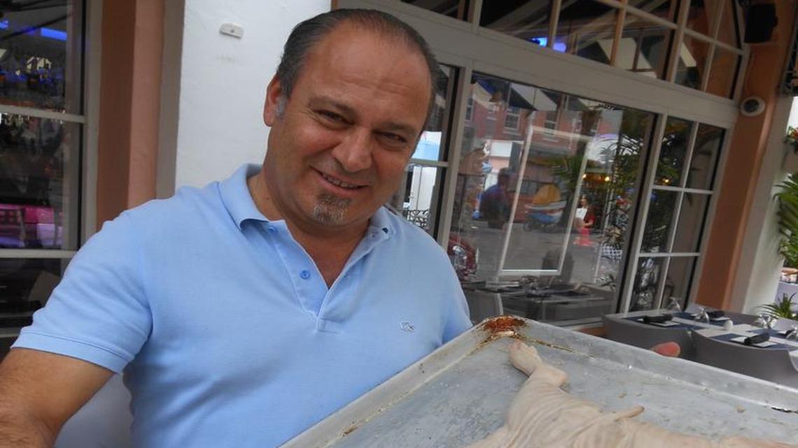 Owner Claudio Giordano with a whole suckling pig that will be roasted (call one day ahead to order one) at his restaurant Mare Mio (My Sea) on Española Way, Miami Beach.