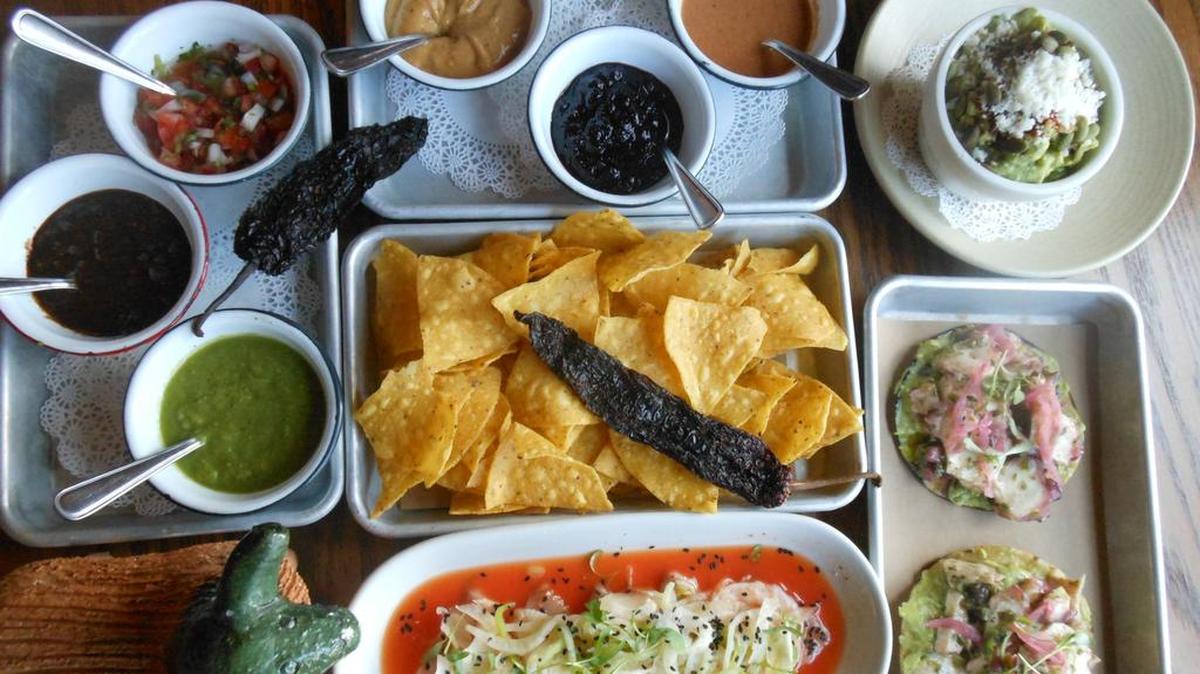 Chips and various salsas, aquachile rojo (Mexican ceviche in red chile sauce), octopus tostadas, and guacamole at Lolo’s Suf Cantina, South of Fifth, Miami Beach.