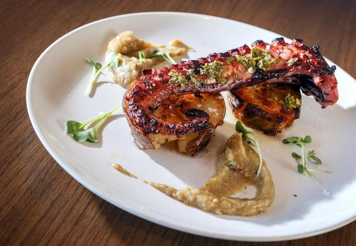 A char-grilled tentacle of octopus is served on eggplant puree at Paon Eatery Tapas Bar