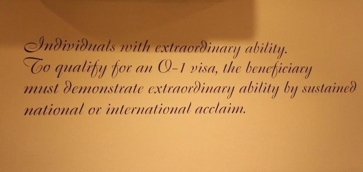 A description of the U.S. O-1 visa is printed on the wall of chef and co-owner Renato Viola’s Miami Beach pizzeria, Mister O-1.