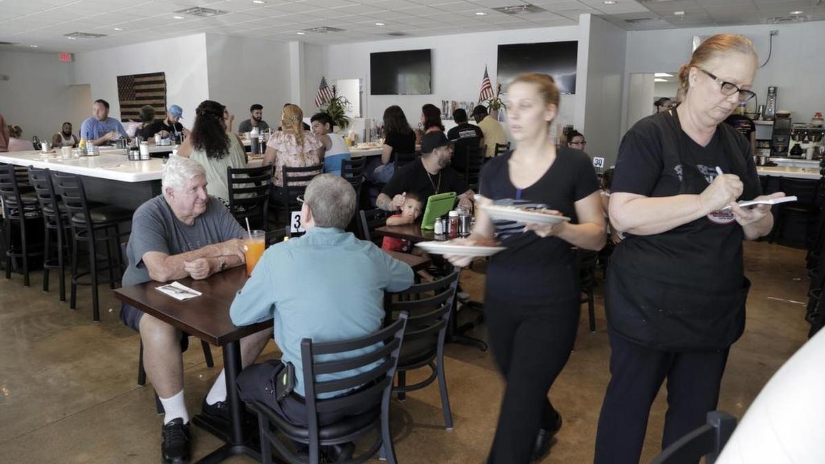 Waitresses move about quickly with orders for customers at Walter’s Coffee Shop.