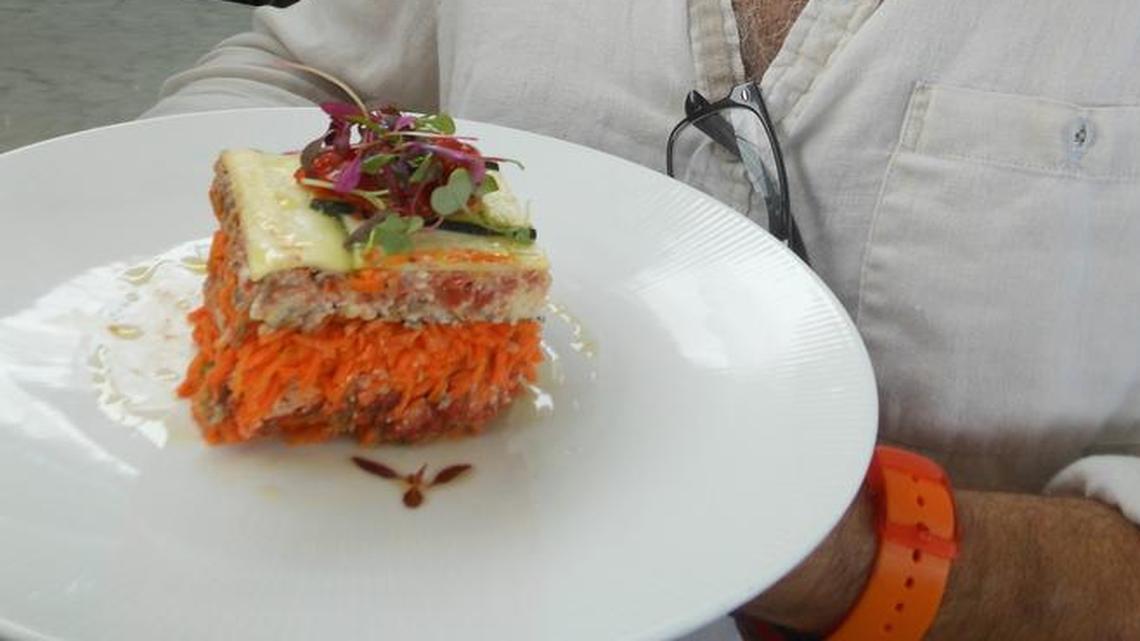 Chef Mark Zeitouni with ‘living lasagne,’ a chilled layered raw terrine served at Lido Bayside Grill, Miami Beach.