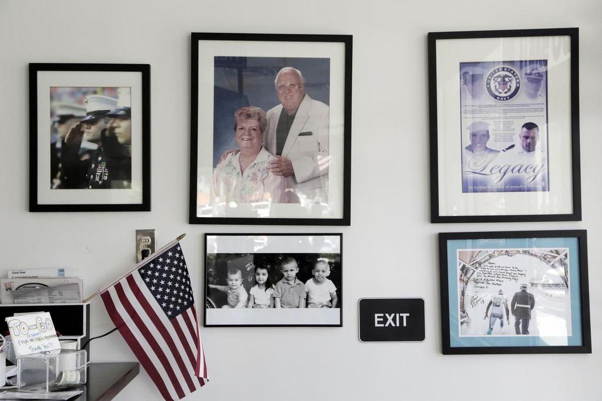 A photo of Walter and Jo Bergamo hangs on the wall by the takeout counter in Walter’s Coffee Shop along with other family photos and photos of Adam Berbick as a Marine.