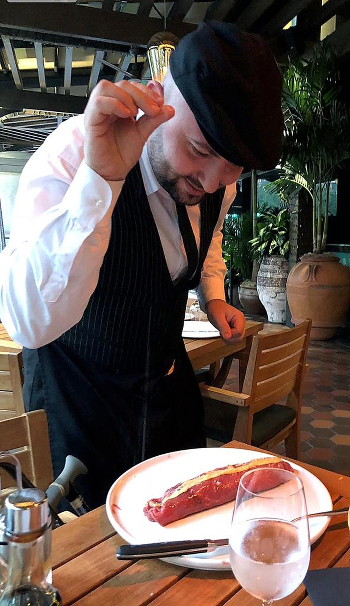A waiter stands in for the abscent “Salt Bae” at Nusr-Et Steakhouse