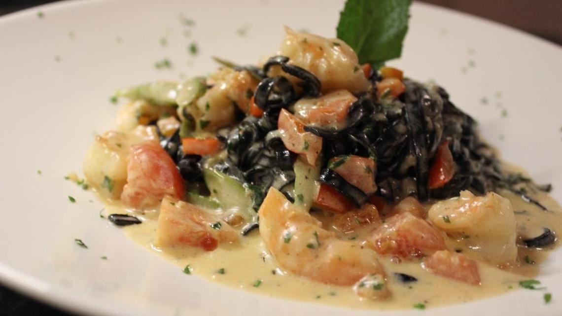 Fresh squid ink black linguine tossed with seafood in an aromatic pomodoro sauce.