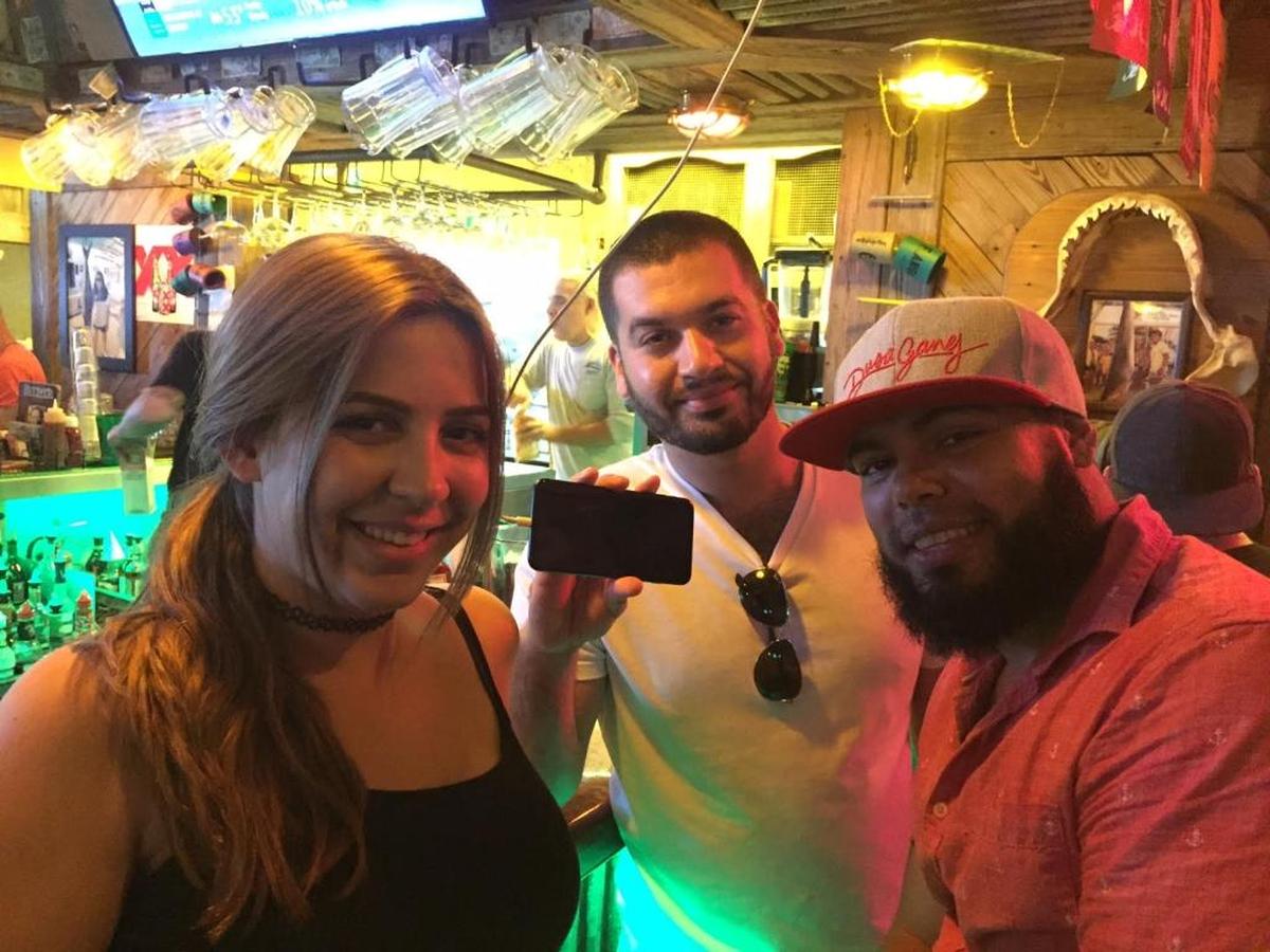 Amanda Mendez fueled herself and her cell phone at Flanigan’s, where she met up with friends Alex Rojas and Chester Cruz.