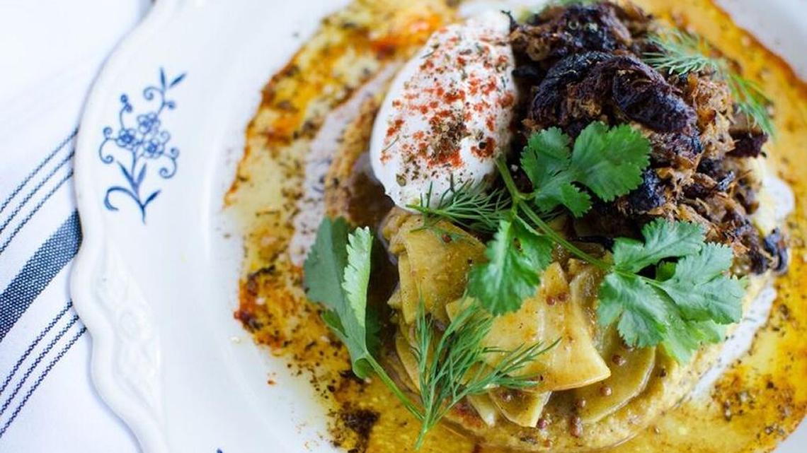 Braised lamb with house pickles, hummus and labneh.