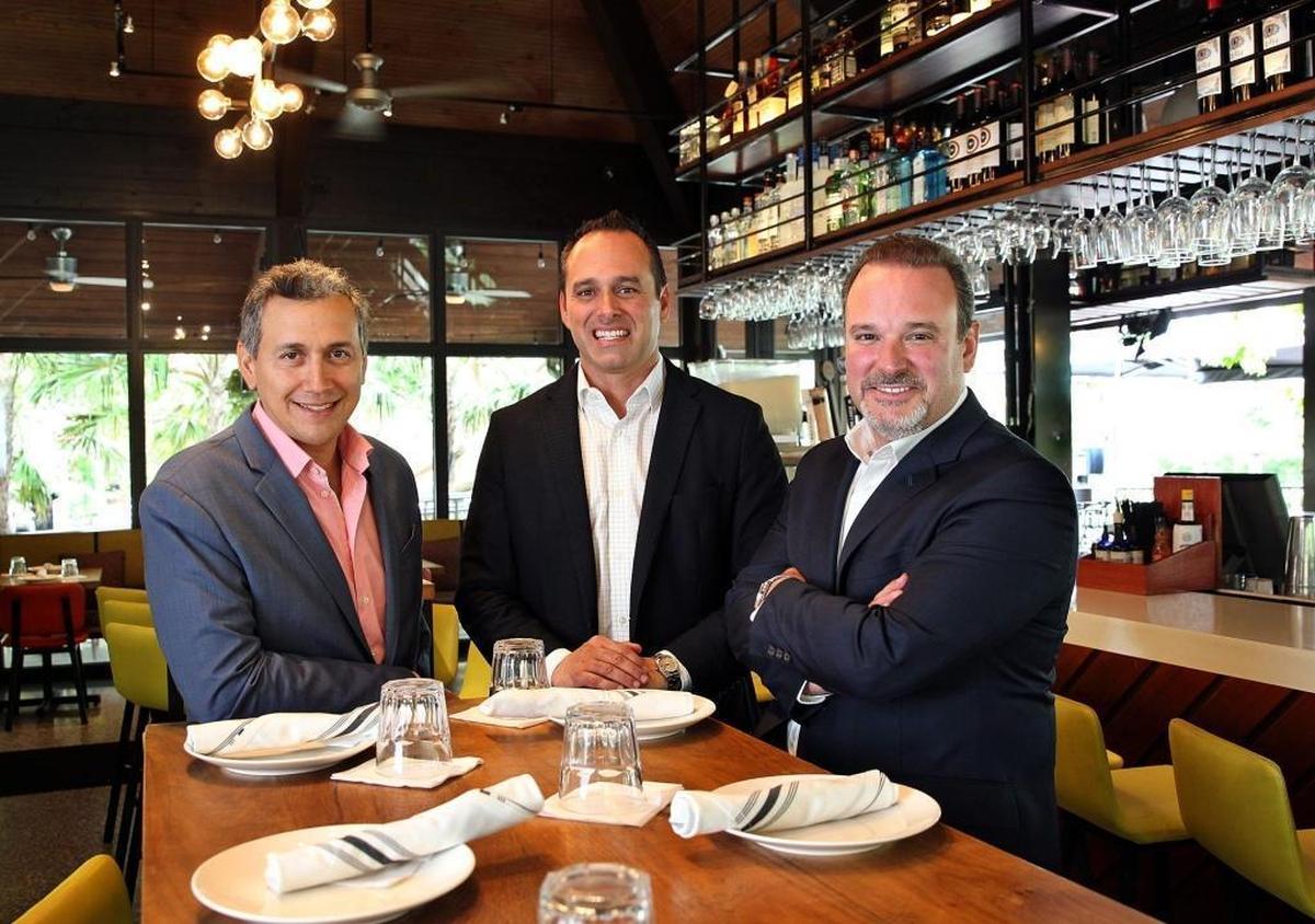 Eddie Acevedo, Ignacio Garcia-Menocal and Francesco Balli, partners of Grove Bay Hospitality Group. at Glass and Vine, one of their restaurants in Coconut Grove. They also own The Big Easy, American Harvest and Shula 347.