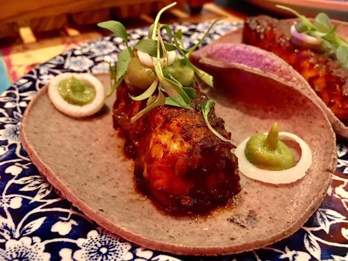 Talla fish taco is blackened in spicy adobo with avocado puree at Tacology.