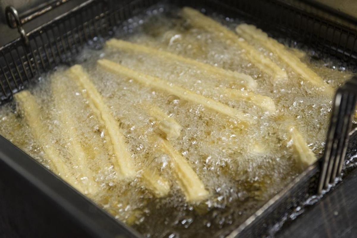 Churros are fried at La Palma Restaurant. Lines formed outside the restaurant as many waited for the opportunity to purchase churros and hot chocolate.