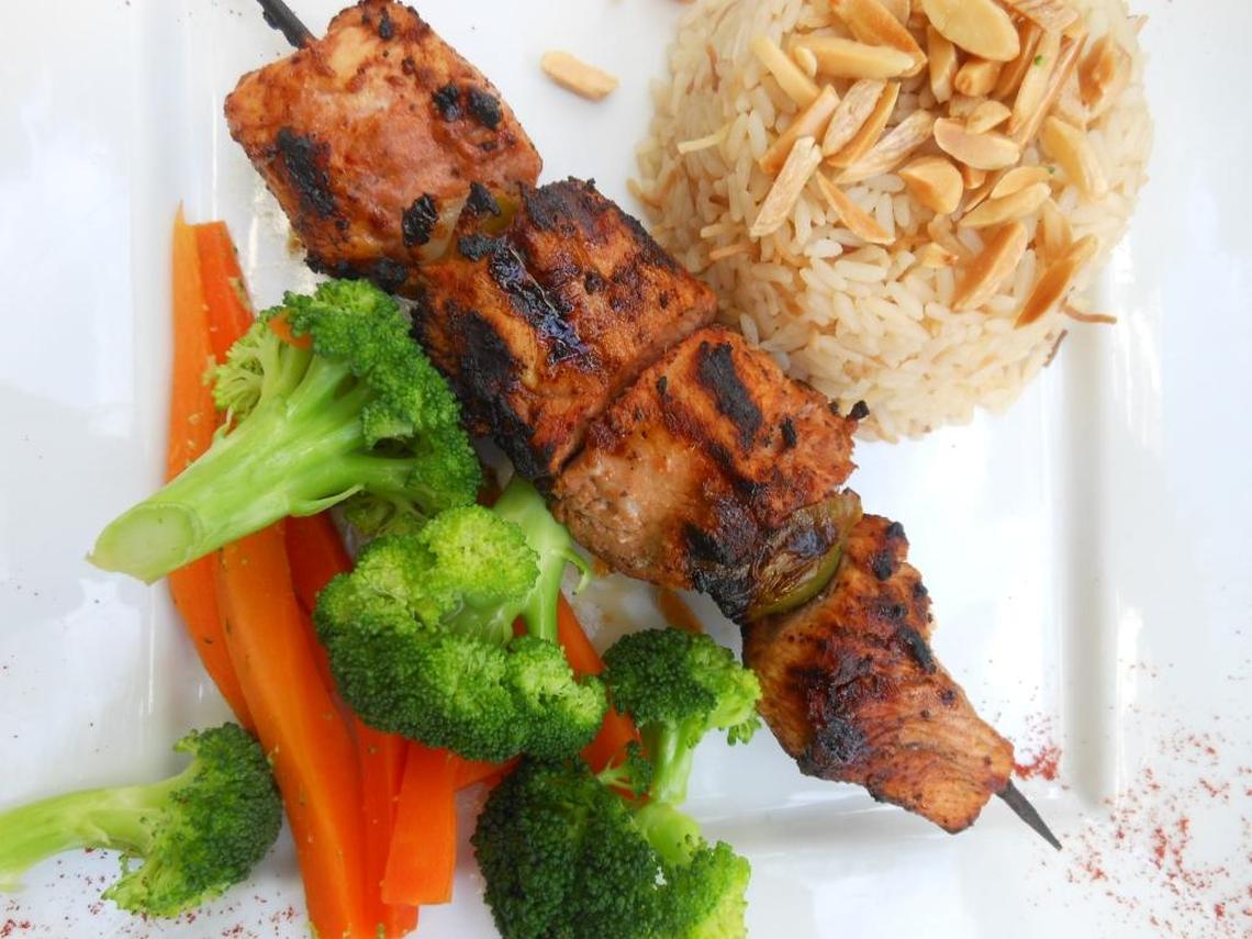 Chicken kebab with almond rice and vegetables.