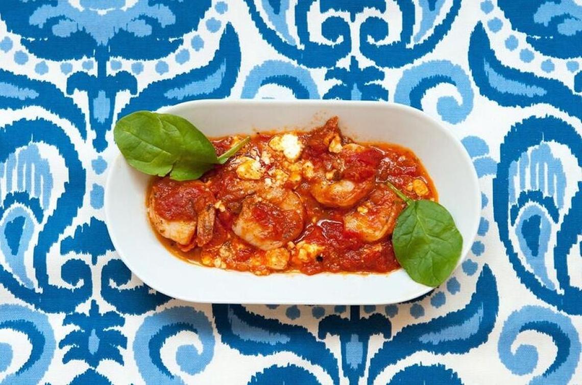 Shrimp and feta saganaki in tomato sauce with basil.