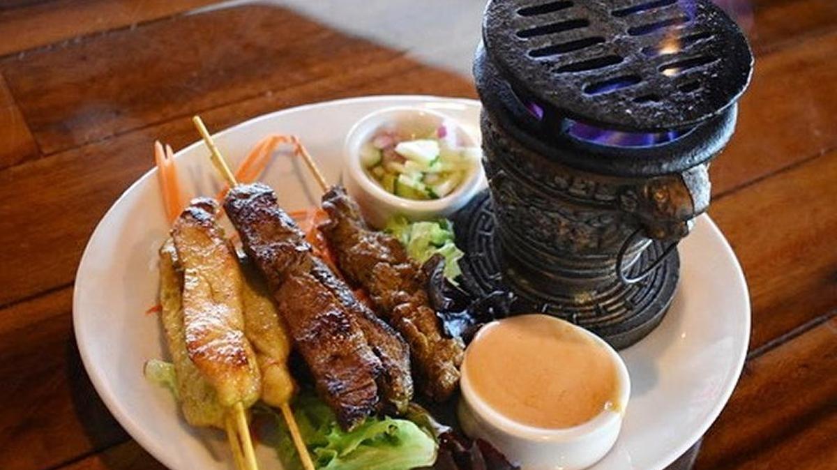 The satay is seared tableside, with an option of chicken, steak or a combination of both.