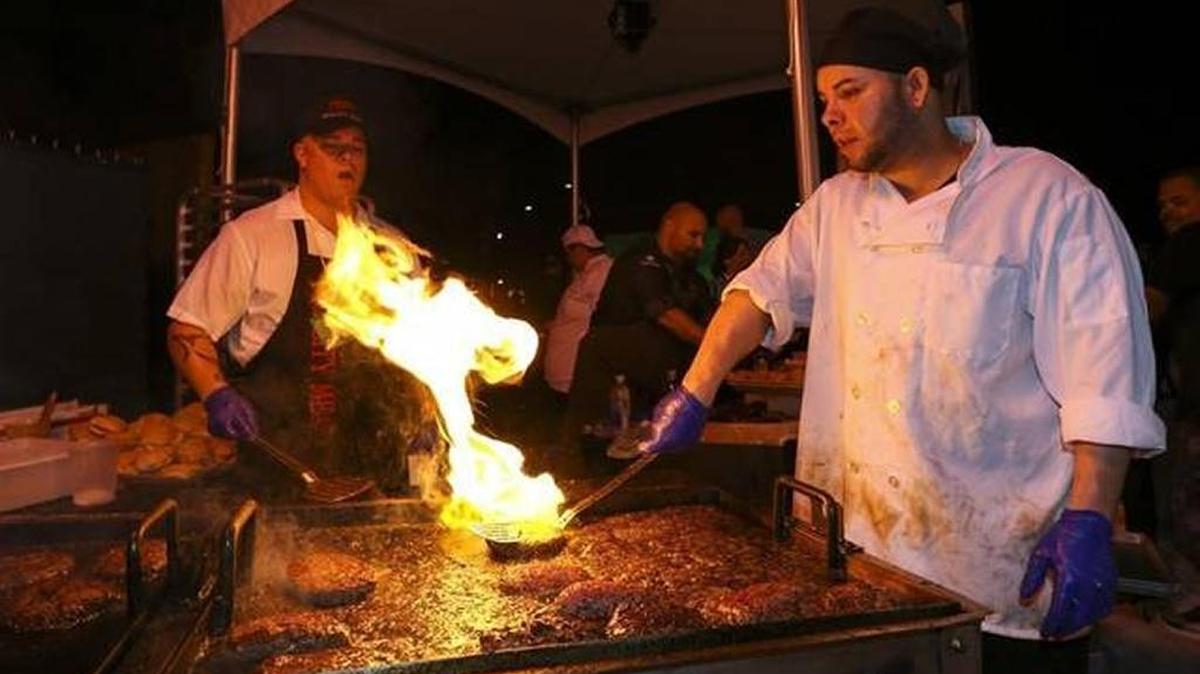 Sandy Rodriguez prepares a Quality Meats' Bacon PB&JJ Burger during Burger Bash at the 2017 South Beach Wine & Food Festival.