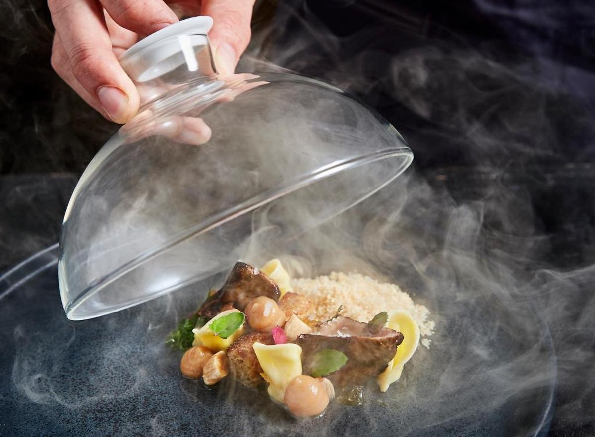 Expect artistic presentation at Jeremy Ford's Time Out Market outpost, inspired by dishes at Stubborn Seed, such as this smoked foie gras under a glass cloche.