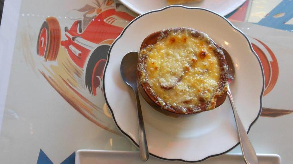 From the top, baked brie and apple slices, French onion soup and a crab cake at Bistro 1902, Hollywood.