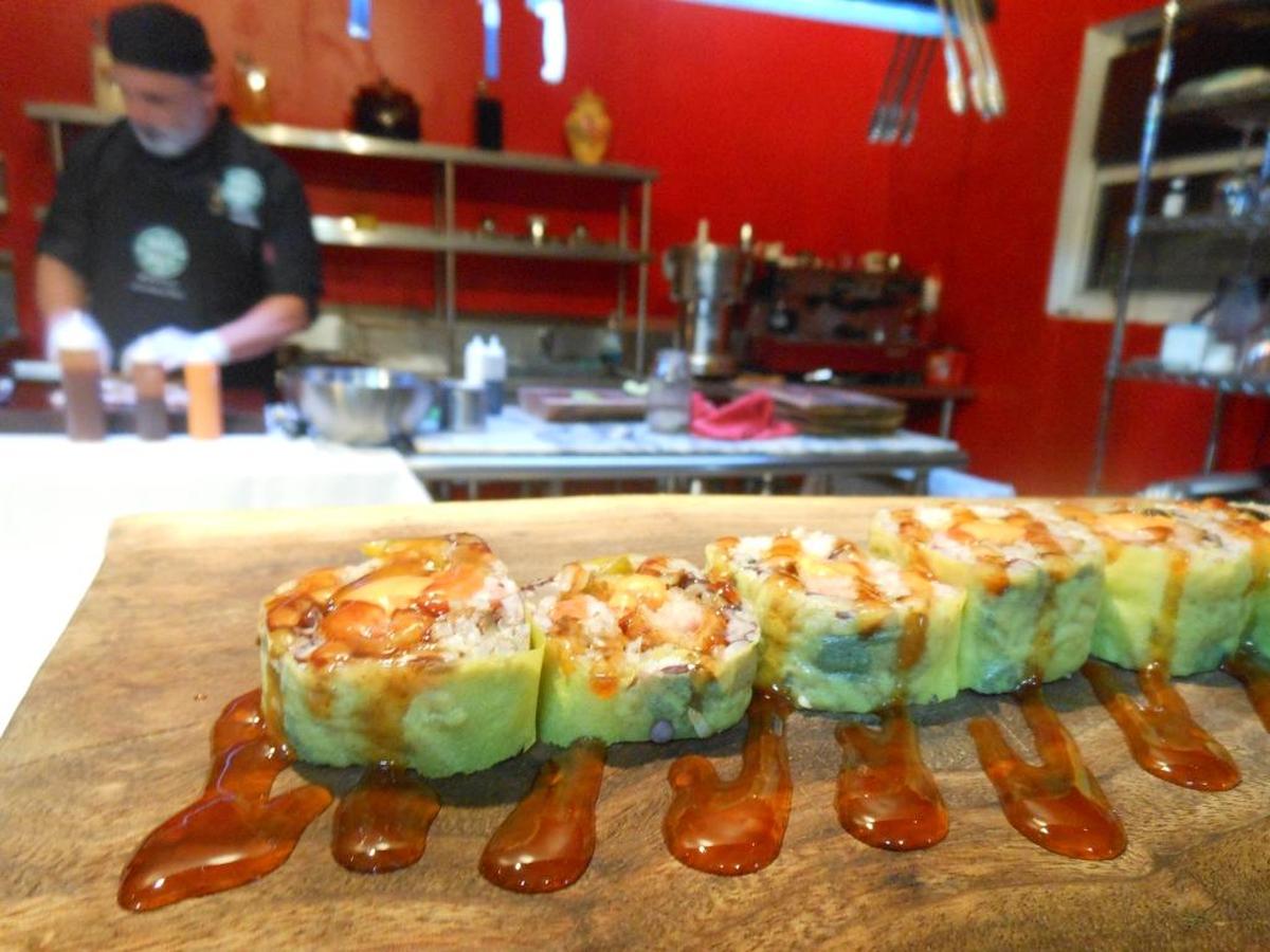 The Caribbean roll with rice and black beans, small corn tamale, bell pepper and avocado with sweet and spicy sauce.