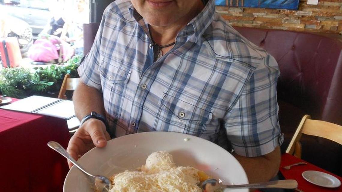 Owner Chris Sorica with a bowl of polenta-like cornmeal mamaliga with salty cheese and sour cream at La Vendetta.