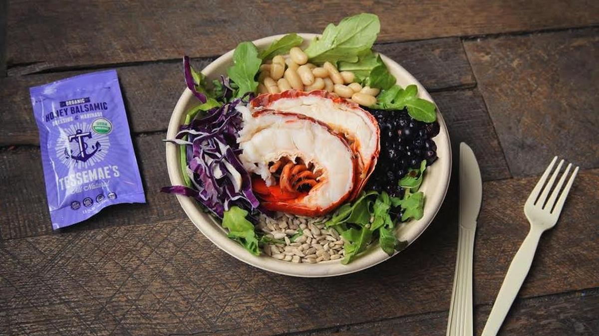 The Luke’s Lobster Wild Blue salad with arugula and pickled blueberries is peppery and tangy sweet, with a crunch from shreds of red cabbage and salted sunflower seeds, all topped with a halved lobster tail in the shell.