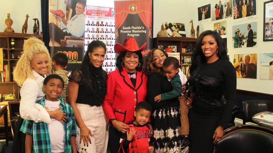 Congresswoman Frederica Wilson (center) is surrounded by the cast of Bravo’s ‘Real Housewives of Atlanta’ and some of their children at her Washington, D.C. office.