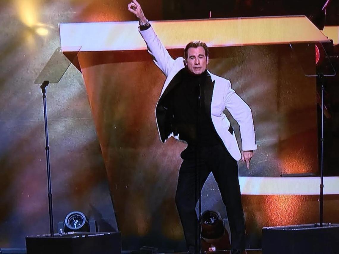 John Travolta gives in to one of his urges, the “Saturday Night Fever” finger point dance move in this screengrab from CBS’ broadcast of “Stayin’ Alive: A Grammy Tribute to the Bee Gees” on Sunday, April 16, 2017.