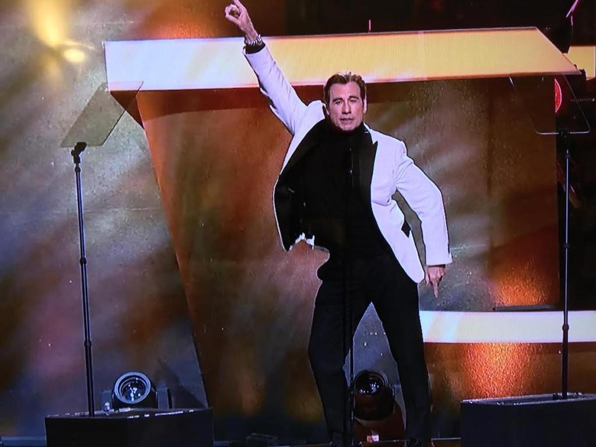 John Travolta gives in to one of his urges, the “Saturday Night Fever” finger point dance move in this screengrab from CBS’ broadcast of “Stayin’ Alive: A Grammy Tribute to the Bee Gees” on Sunday, April 16, 2017.
