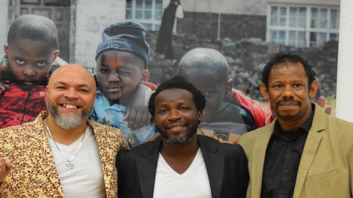From left: Saddi Khali in front of one of his photos with Bart Mervil of M.U.S.E. and fellow artist LeRoy Hazzard.