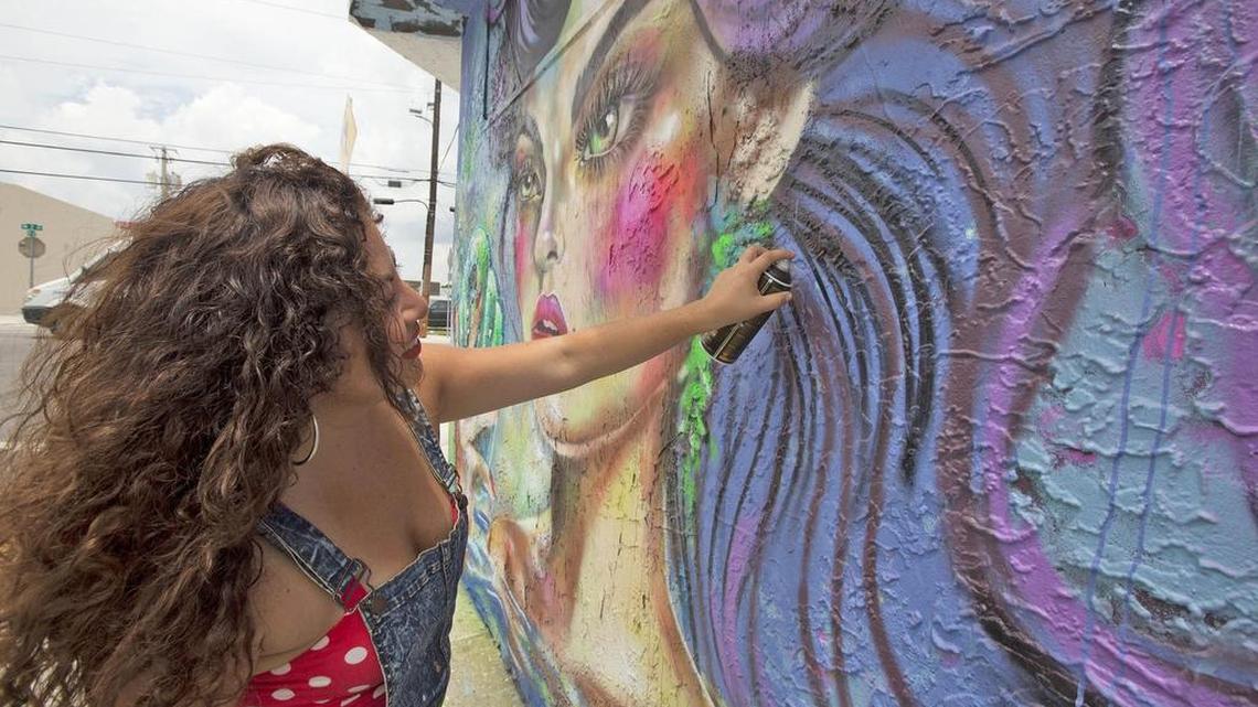 
Diana ‘Didi’ Contreras works on her mural ‘Shellfie of the Mermaid’ in Wynwood.
