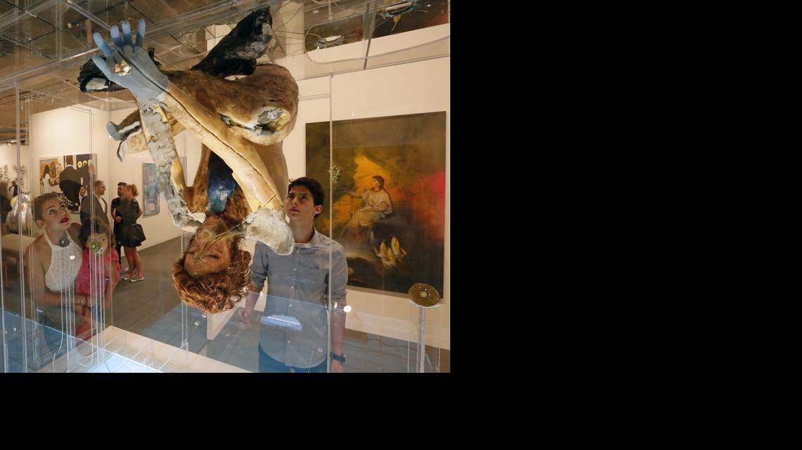 
Stelle Rayne with daughter Belle Gonzalez, 2, and husband Beto Gonzalez view ‘Daybreak’ by David Altmejd during the VIP opening day of Art Basel Miami Beach at the Miami Beach Convention Center on Wednesday, Dec. 3, 2014.
