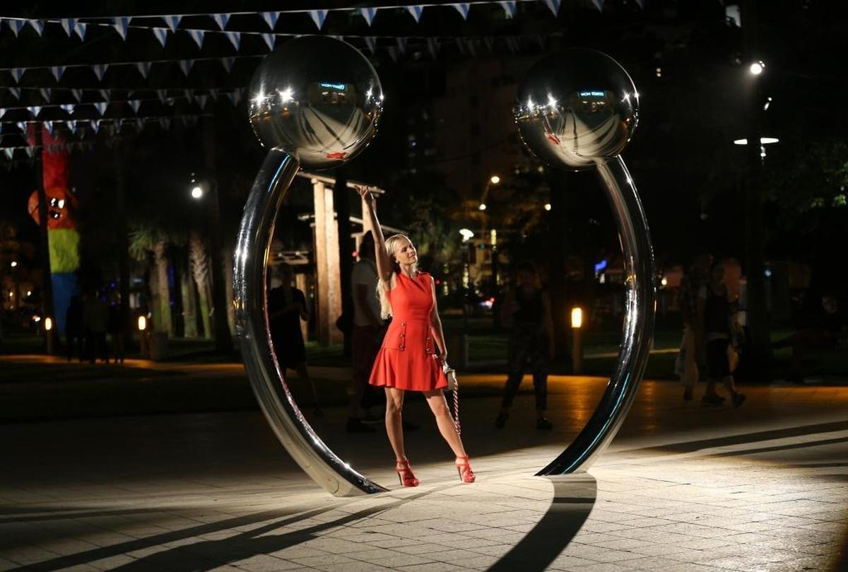 Tatyana Zemskova poses by the piece “Some guy with a piercing” by artist Daniel Knorr, on display as part of Art Basel Public, curated by Philipp Kaiser at Collins Park in Miami Beach on Wednesday, Dec. 6, 2017.