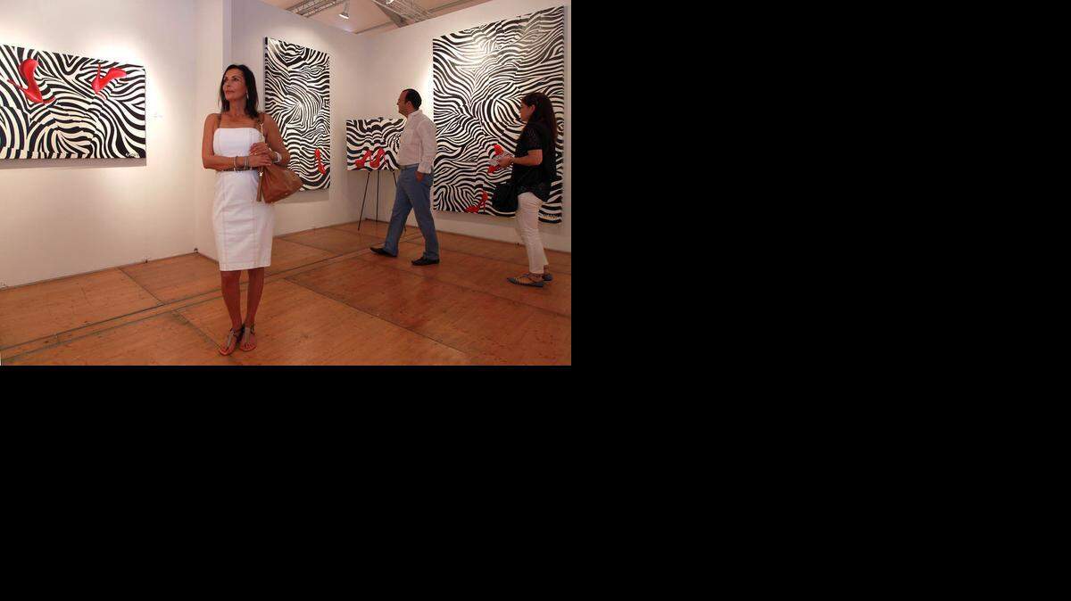
Ghada Dergham looks at the art work of the Zebra Love exhibit by Blake Emory, a concept work in 'Optic Modernism, at the Spectrum art fair, Saturday, Dec. 6, 2014, in Midtown Miami.
