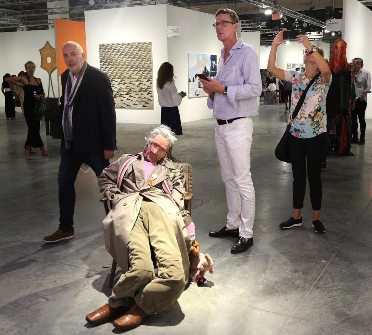 On Wednesday, attendees of Art Basel navigate around Pawel Althamer’s piece “wujek cziko” at booth of Nueger-Riemschneider of Berlin during the VIP opener at Art Basel at the Miami Beach Convention Center.