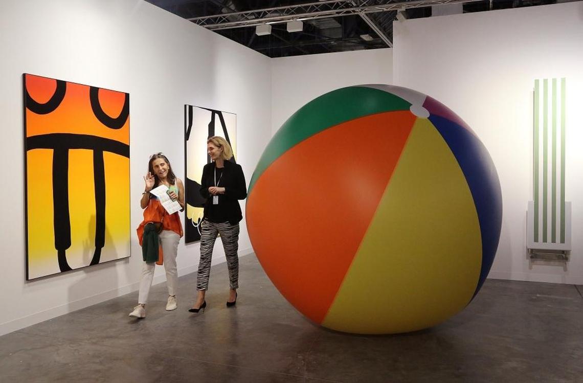 Fusun Eczacibasi, left, tours the Nicolai Wallner gallery booth, from Copenhagen, with art agent Gitte Sjkodt Madsen, right, during the VIP opener at Art Basel Miami Beach.