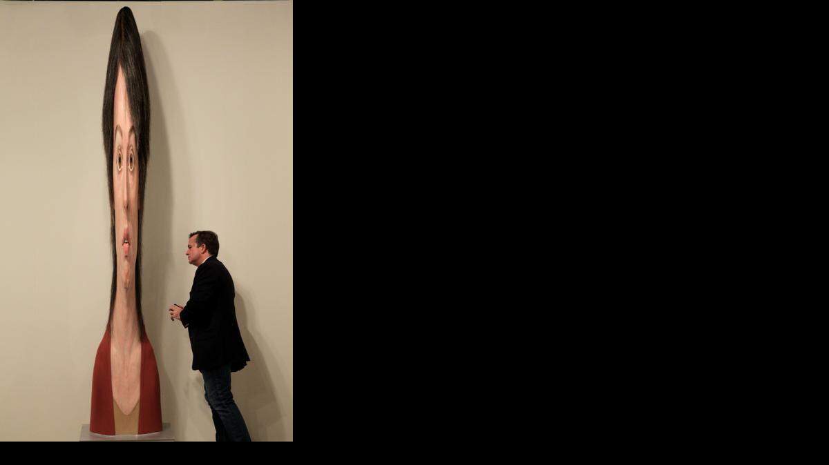 tall order:  Patrick Wall views ‘Female Stretch’ by Evan Penny during Art Basel 2013.
