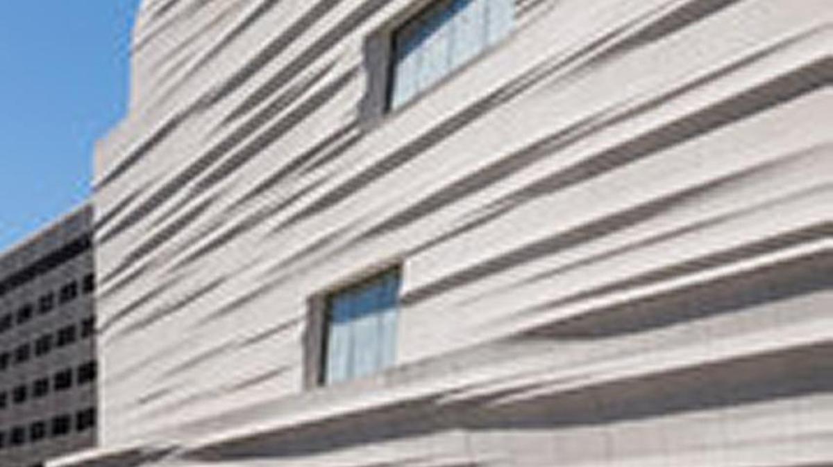 The new building’s rippling, sloping facade.