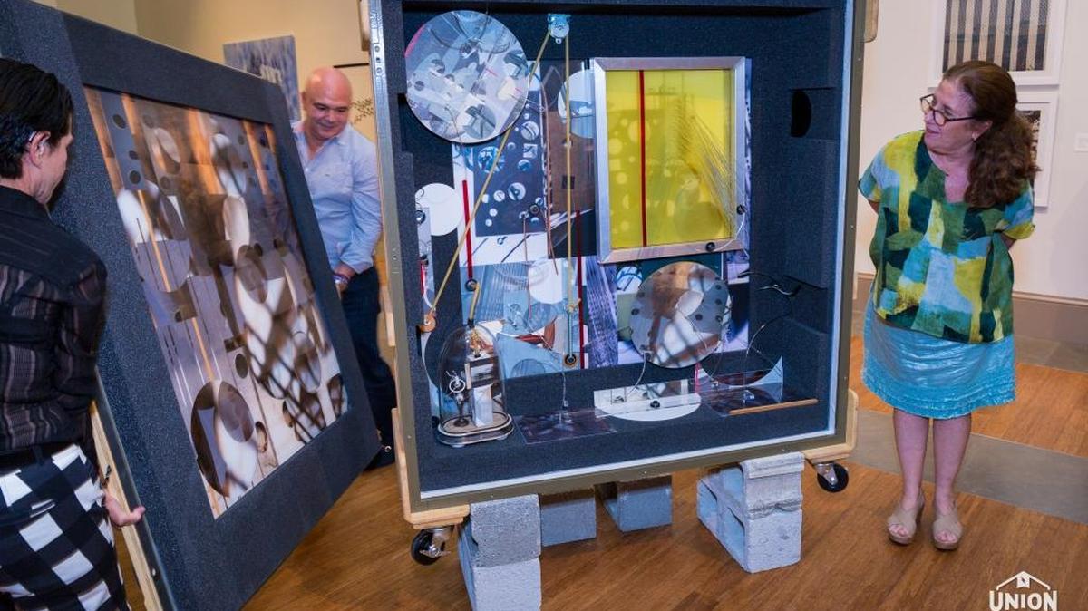 Maria Martinez Canas, who was born in Havana and lives in Miami, unveils her mixed media piece “Rebus + Diversions: Untitled 023” during opening night.