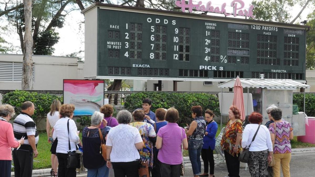 Teaching artist Juan Campos gives a tour of PAMM’s artwork reproductions in Hialeah Park to a group from City of Hialeah Adult Centers. Exhibited is Ed Clark’s “Pink Wave,” 2006.