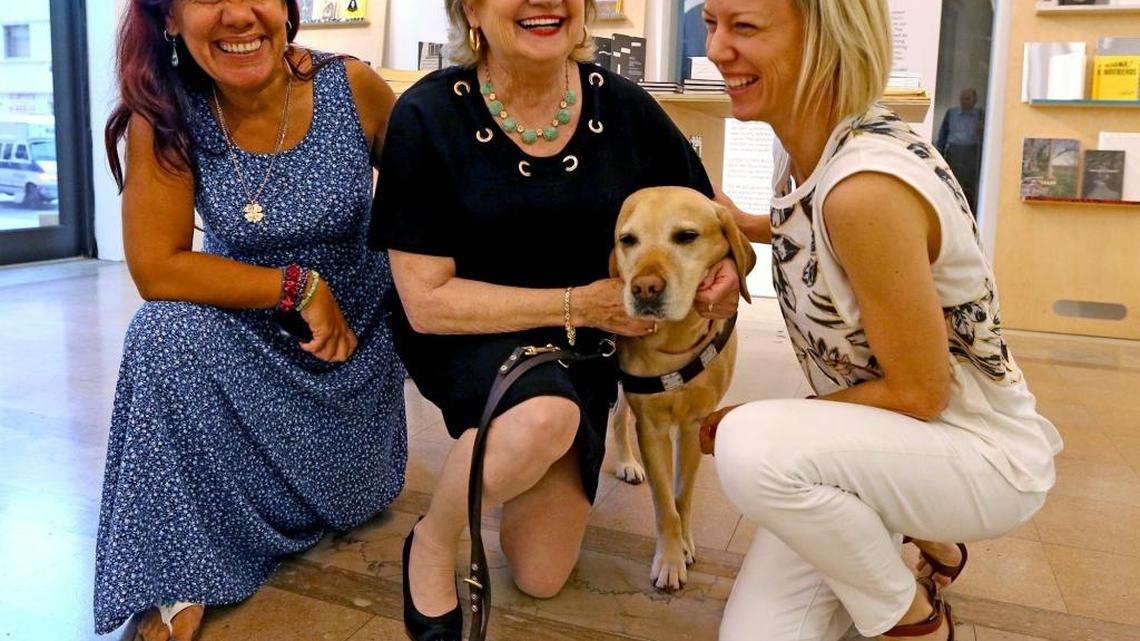 
Nelba Gonzalez, Virgina Jacko and Amanda Keeley with Jacko’s service dog, Kieran, on Sept. 8, 2015, at a Miami Lighthouse for the Blind art display created by visually impared people.
