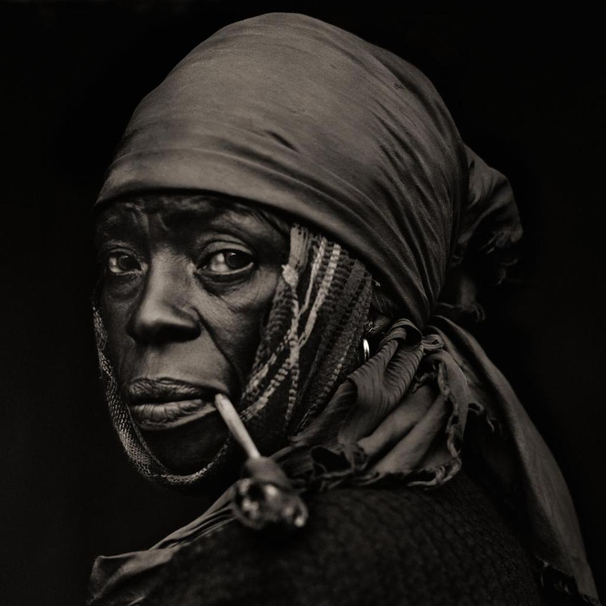“Woman with Pipe, Traditional Medicinal Plant Healer, Haiti,” 1984. From the show “DIGNITY: Tribes in Transition,” photographs by Dana Gluckstein, at the Lowe Museum of Art through April 22, 2018.