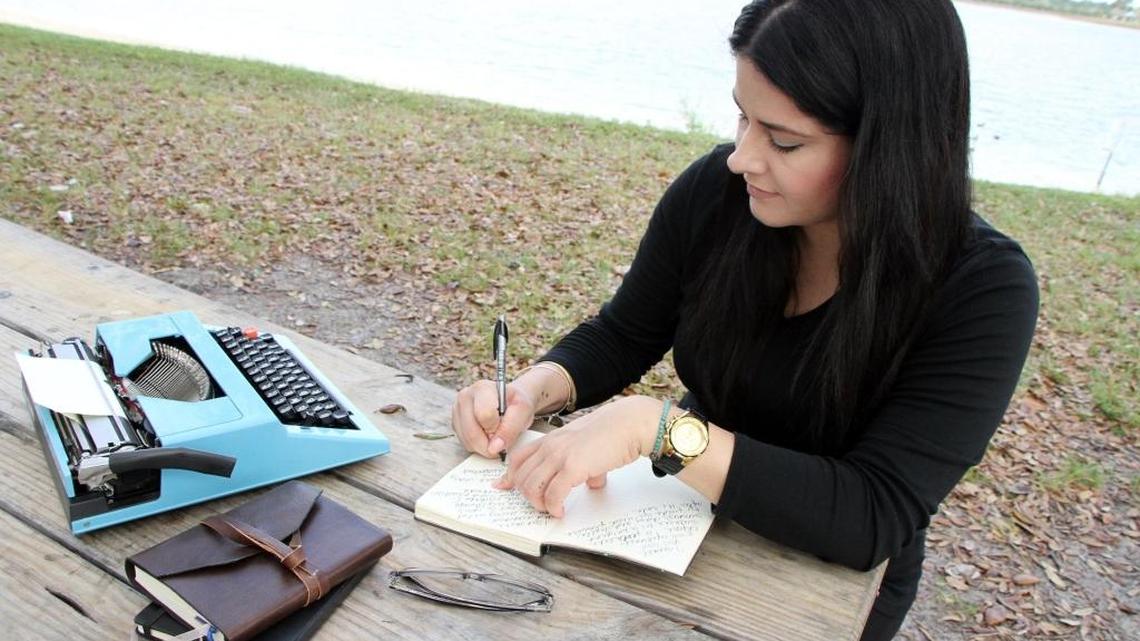 Michelle Morgan poses as she writes in one of her journals at Larry and Penny Thompson Park, where she often writes and walks close to her home, near Cutler Ridge, on Wednesday, March 16, 2016.