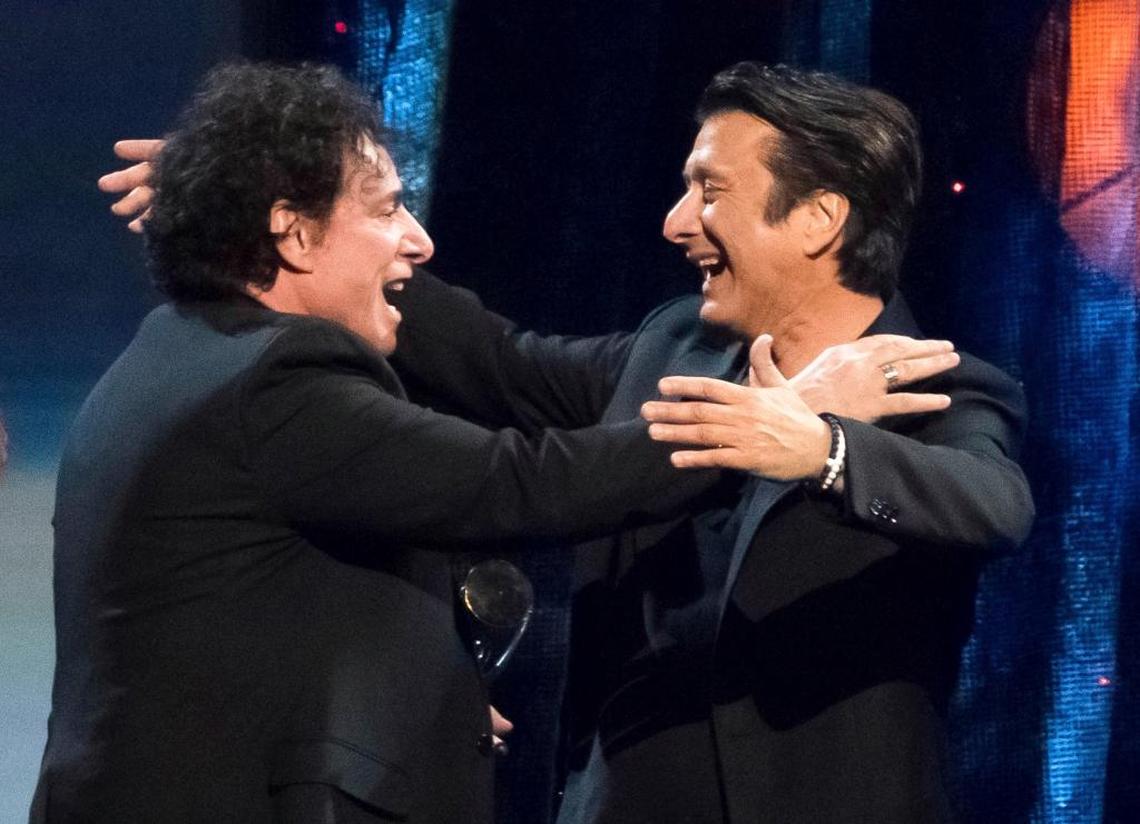 Inductees Neal Schon, left, and Steve Perry, right, the long departed lead singer of Journey, embrace at the 2017 Rock and Roll Hall of Fame induction ceremony at the Barclays Center on Friday, April 7, 2017, in New York. Perry did not sing with Journey at the ceremony.